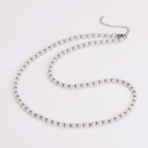 Detail of vintage faux pearl necklace with silver metal beads and adjustable extension chain