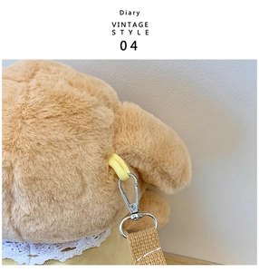 Detail of plush brown bag with white lace trim and yellow webbing shoulder strap