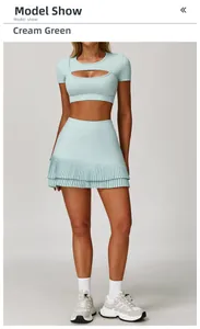 Detail of cream green sports set with cutout short sleeve top and pleated athletic skirt
