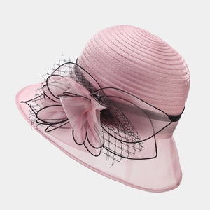 Detail of elegant pink organza sun hat with large floral applique and black mesh texture
