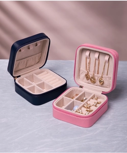 Navy and pink travel jewelry boxes showing interior necklace hooks and ring slots
