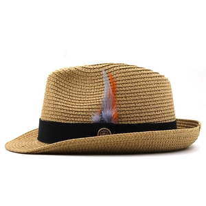 Classic straw fedora sun hat with black ribbon and decorative feather for beach vacation