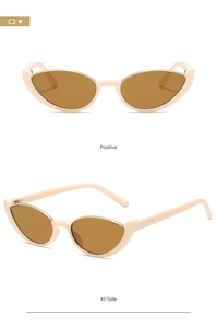 Detail view of cat eye sunglasses in beige with golden metal rim and dark lenses