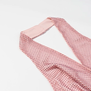 Pink mesh halter top for women with sparkling rhinestone embellishments on a plain background