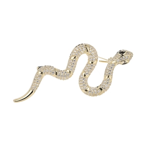 Elegant gold snake brooch with sparkling cubic zirconia and black gem eyes on white background