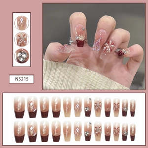 Detail of N5215 deep red gradient press-on nails with rhinestone and pearl accents