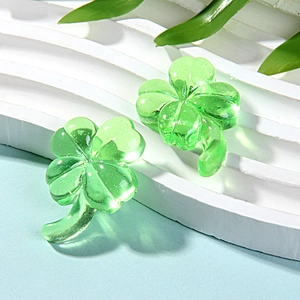 Macro shot of green translucent resin clover charms with glossy finish for DIY jewelry