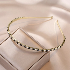 Elegant emerald-green and clear zircon cross headband on a golden metal frame for women