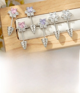Detailed view of heart-shaped zircon cat paw earrings with tiny diamond edge settings