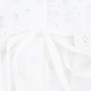 White short sleeve shirt dress featuring delicate eyelet embroidery and a waist tie detail