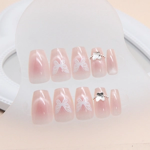 Pink cat-eye press-on nails with 3D silver butterflies and gradient coffin shape
