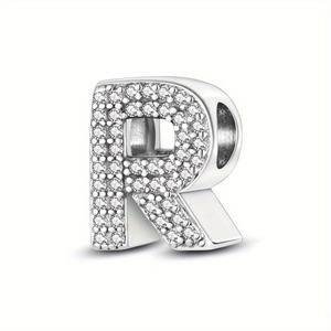 Detailed view of silver letter R charm bead with sparkling cubic zirconia crystals