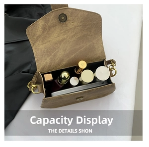 Internal capacity display of a brown vintage satchel with phone and cosmetics