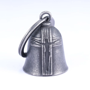 Close-up of vintage stainless steel motorcycle bell featuring an embossed cross design
