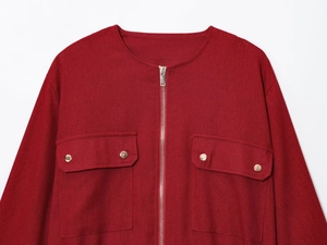 Detail of red linen blend jacket featuring a round neck and silver metal zipper pockets