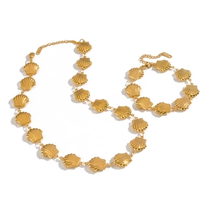 Golden stainless steel necklace and bracelet set featuring handmade shell-shaped charms