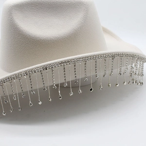 Detailed view of cream western cowboy hat featuring sparkling rhinestone fringe edges