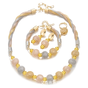 Macro detail of tricolor mesh jewelry set including necklace, bracelet, earrings and ring