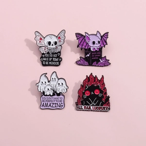 Set of four spooky enamel pins featuring skull butterfly, bat, ghost and cat on pink background