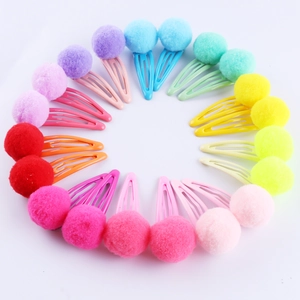 Multi-color plush pom pom hair clips for kids arranged in a circular set pattern