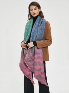 Detail of zebra pattern pashmina shawl featuring vibrant green and purple color blocking