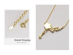 Detail of S925 sterling silver flower and key pendant with gold plating and hallmark