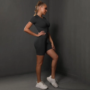 Detail view of seamless high-stretch yoga shorts and crop top set in charcoal grey color