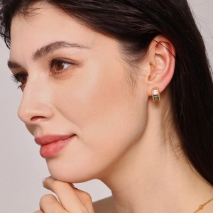 Rainbow gemstone ear cuff in gold-plated copper shown on model with colorful stones