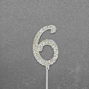 Detailed view of silver number 6 cake topper with sparkling rhinestones for parties