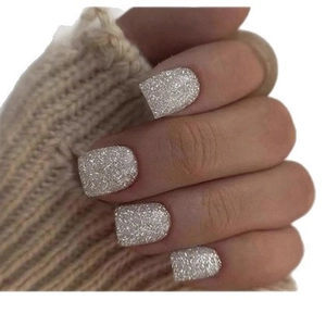 Short square silver glitter press-on nails for women on a cozy sweater background