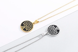 Detailed view of round gold and silver Tree of Life pendants on a clean white background