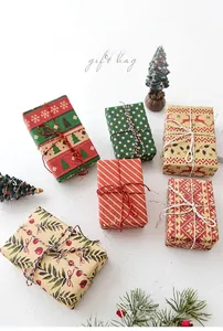 Flat lay of six assorted festive Christmas gift bags with colorful cotton rope ties