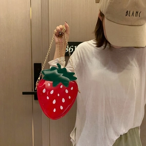Detailed view of creative strawberry-shaped red PU leather shoulder bag with gold chain