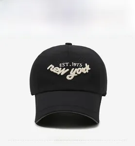 Detailed view of 3D letter embroidery and breathable fabric on a black baseball cap