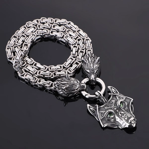 Detailed view of silver Viking wolf head pendant with complex Byzantine chain necklace