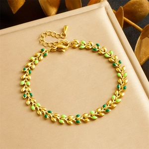 Gold leaf chain bracelet with green enamel on a jewelry box gift presentation