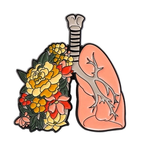 Enamel brooch with human lung anatomy design featuring colorful floral decorations
