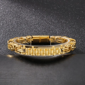 Close-up of golden stainless steel curb chain bracelet with watch-style link detail