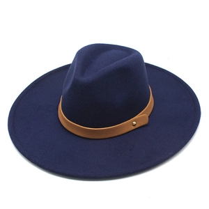Detail of dark blue wool felt fedora with light brown leather band and gold stud