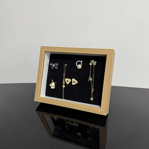 Elegant jewelry display box with wooden frame and black velvet lining for rings and studs
