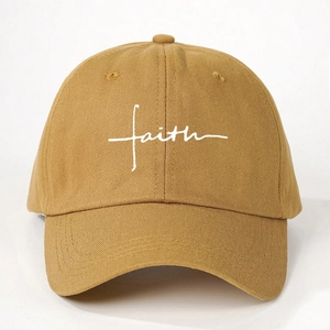 Macro detail of Faith embroidery on khaki washed cotton twill baseball cap fabric