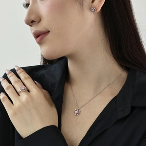 Detail shot of heart-shaped pink zircon jewelry set including necklace, ring and earrings