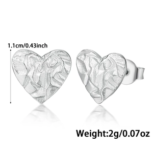 Detail view showing 1.1cm heart earrings with hammered silver texture and dimensions