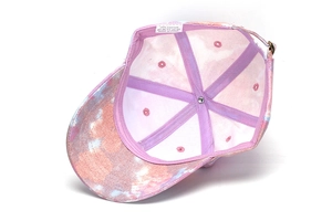 Interior detail of cotton tie-dye baseball cap showing purple seam tape and metal buckle
