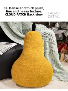 Back view of a pear plush pillow with thick lamb wool texture on a cozy black sofa