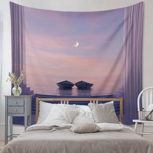Detail of bohemian tapestry featuring a dreamy sunset beach scene above a cozy bed