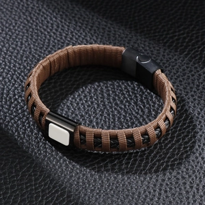 Close-up of woven leather bracelet in brown and black with black magnetic clasp