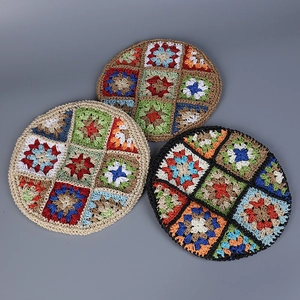 Detail showing three colorful crochet bohemian coasters with handmade granny square pattern