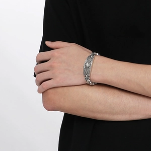 Bracelet vintage en acier inoxydable avec gravure florale losange et finition argent