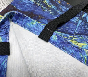 Detail of cross-stitch reinforced black handle on Van Gogh Starry Night canvas tote bag